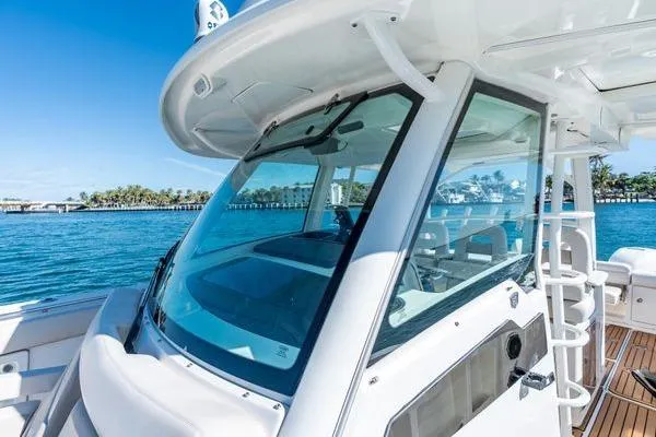  Yacht Photos Pics 2018 Boston Whaler 350 Outrage boat on clear blue water, showcasing sleek design.