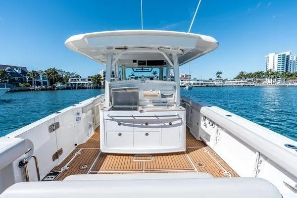  Yacht Photos Pics 2018 Boston Whaler 350 Outrage boat on water, featuring spacious deck and modern design.