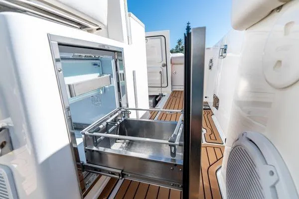  Yacht Photos Pics 2018 Boston Whaler 350 Outrage boat with open stainless steel storage compartment.