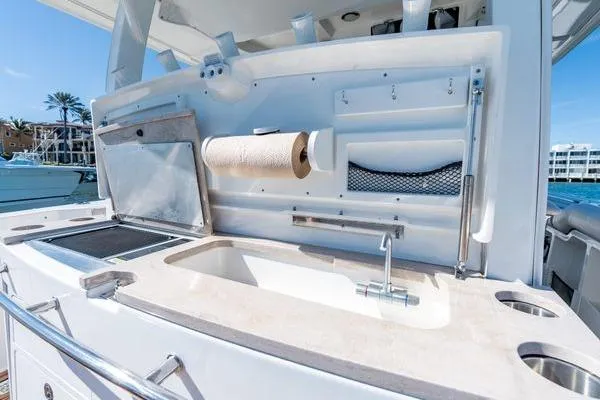  Yacht Photos Pics 2018 Boston Whaler 350 Outrage boat kitchen area with sink and storage.