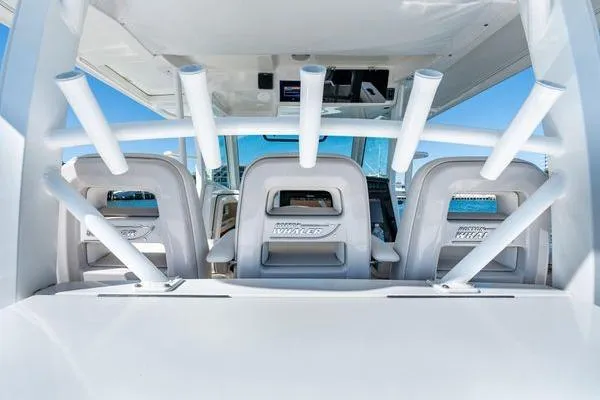  Yacht Photos Pics 2018 Boston Whaler 350 Outrage boat interior with rod holders and seating.