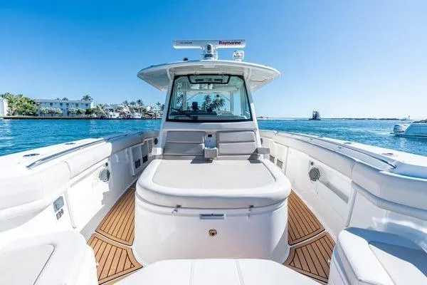 Yacht Photos Pics 2018 Boston Whaler 350 Outrage boat on water, featuring spacious deck and modern design.
