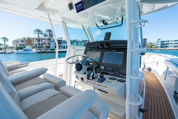  Yacht Photos Pics 2018 Boston Whaler 350 Outrage helm with modern controls, docked near waterfront homes.