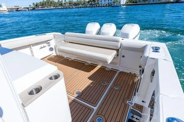  Yacht Photos Pics 2018 Boston Whaler 350 Outrage boat with spacious deck and triple engines on blue water.