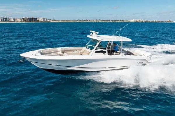  Yacht Photos Pics 2018 Boston Whaler 350 Outrage cruising on open blue water, showcasing sleek design and performance.