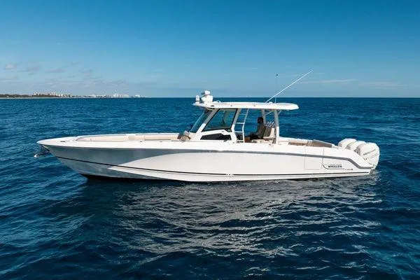 Yacht Photos Pics 2018 Boston Whaler 350 Outrage boat on open sea under clear blue sky.