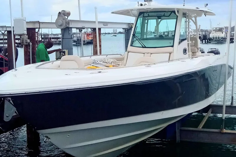  Yacht Photos Pics 2018 Boston Whaler 350 Outrage boat docked at marina, side view.