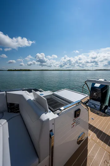 Legacy Yacht Photos Pics 2022 Formula 500 Super Sport Crossover on serene water under blue sky.