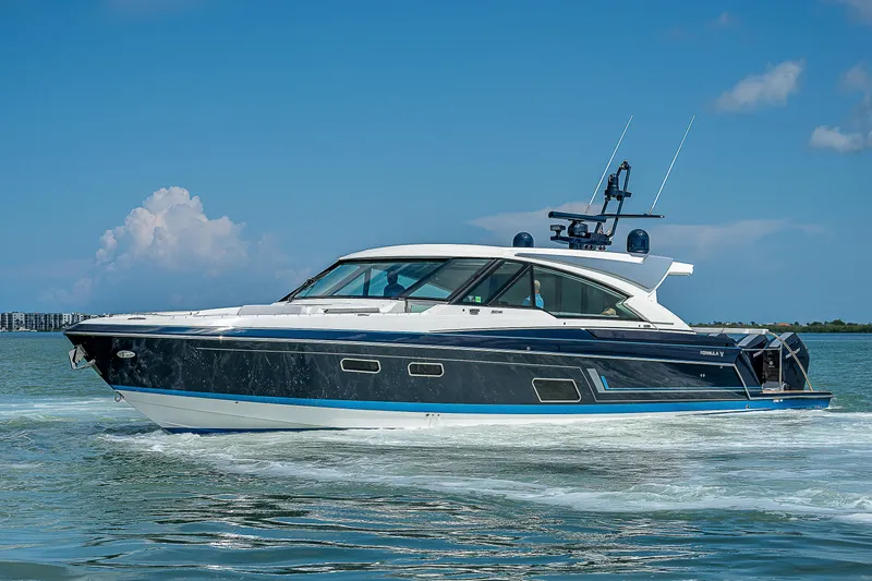 Legacy Yacht Photos Pics 2022 Formula 500 Super Sport Crossover cruising on open water under a clear blue sky.