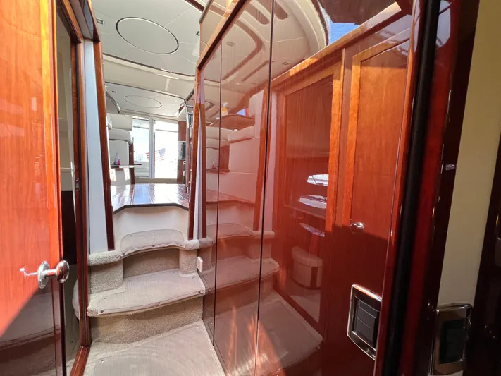  Yacht Photos Pics Interior of 2013 Meridian 441 Sedan yacht with polished wood and carpeted steps.