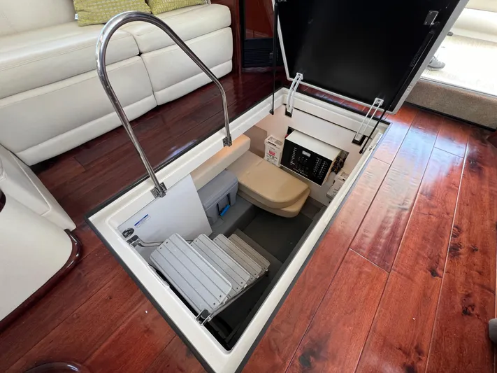  Yacht Photos Pics 2013 Meridian 441 Sedan interior with open hatch revealing storage and control panel.