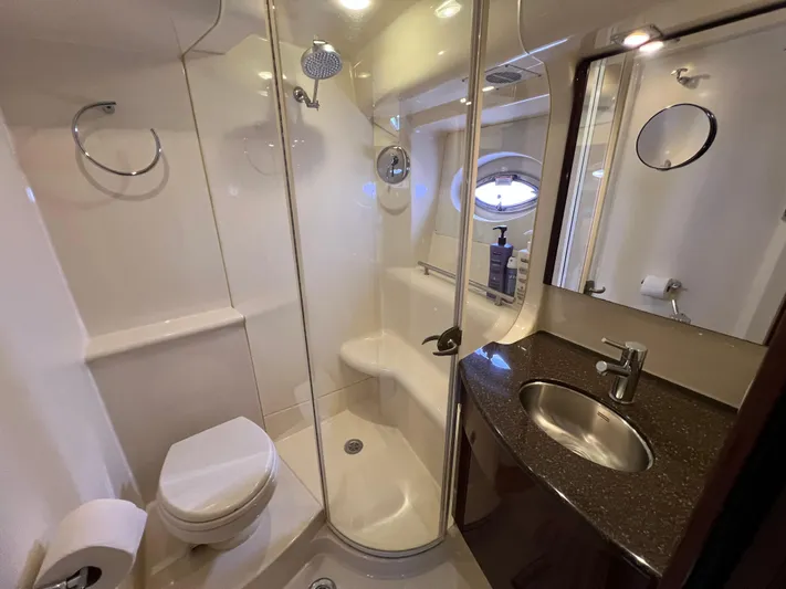  Yacht Photos Pics Luxurious bathroom in 2013 Meridian 441 Sedan yacht with shower, sink, and toilet.