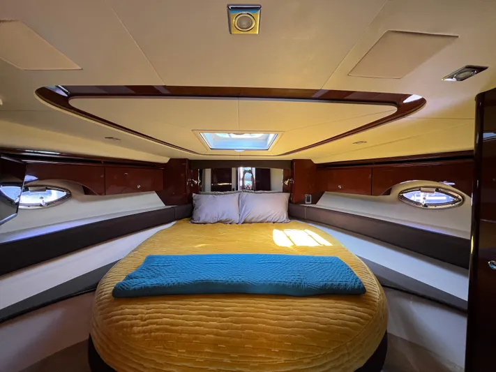  Yacht Photos Pics Luxurious bedroom interior of 2013 Meridian 441 Sedan yacht with skylight and plush bedding.