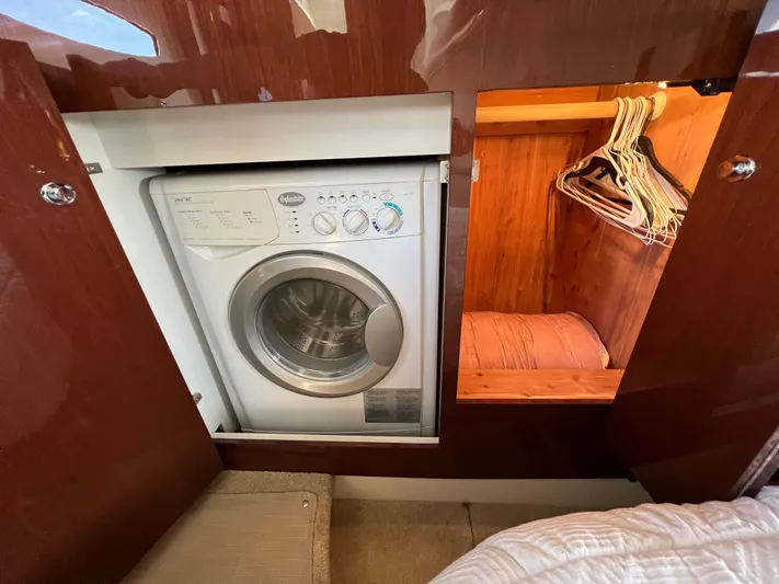  Yacht Photos Pics Laundry area with washer and closet in 2013 Meridian 441 Sedan yacht.