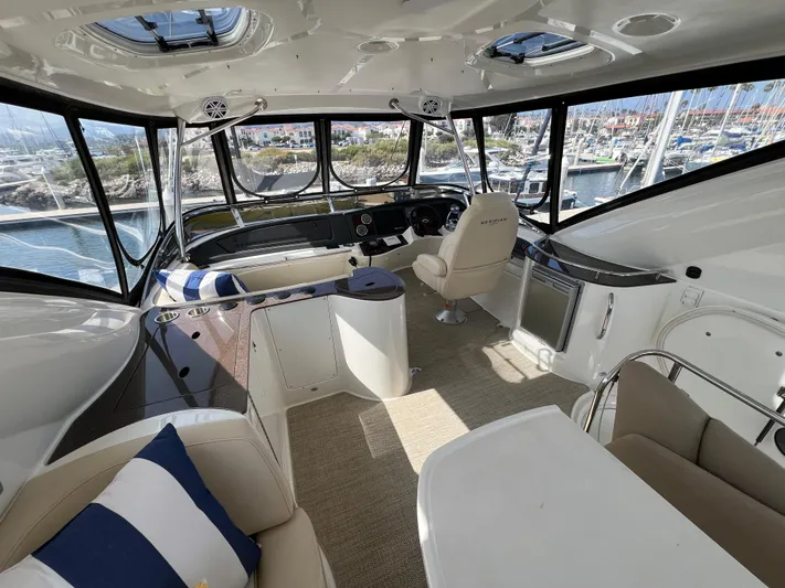  Yacht Photos Pics Interior of 2013 Meridian 441 Sedan yacht with helm, seating, and marina view.