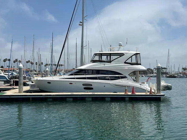  Yacht Photos Pics 2013 Meridian 441 Sedan yacht docked in a marina with sailboats in the background.