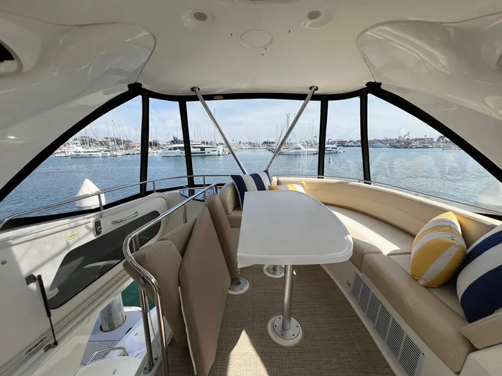  Yacht Photos Pics Interior of 2013 Meridian 441 Sedan yacht with seating and table, overlooking marina.