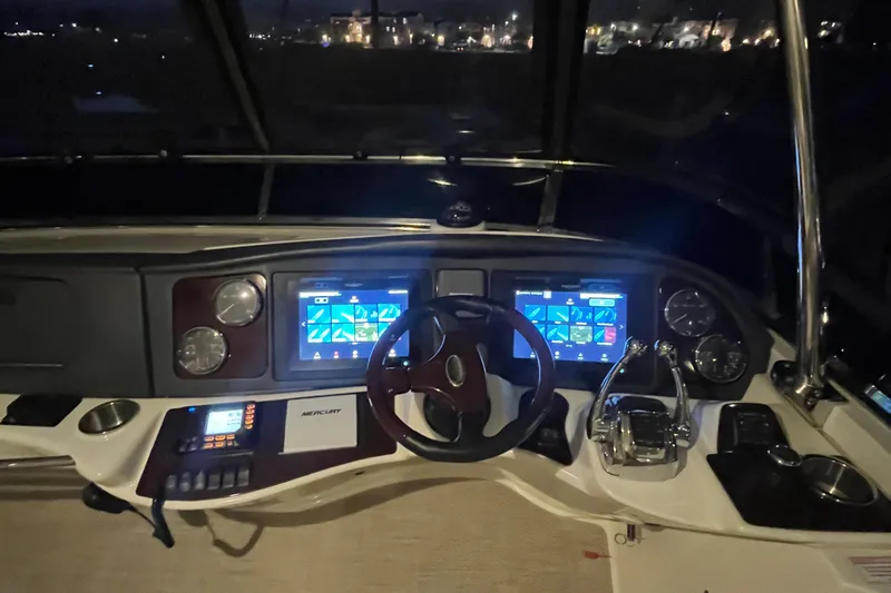  Yacht Photos Pics 2013 Meridian 441 Sedan helm with illuminated controls and navigation screens at night.