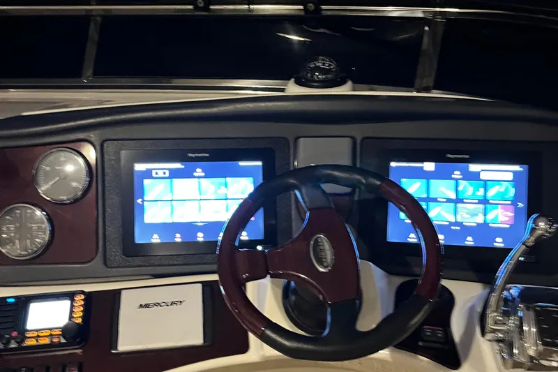  Yacht Photos Pics Dashboard of a 2013 Meridian 441 Sedan with dual screens and steering wheel.