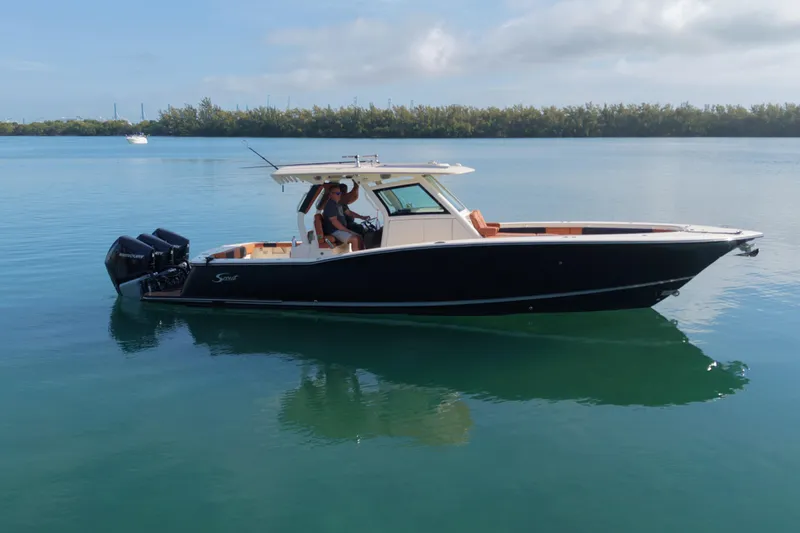  Yacht Photos Pics 2019 Scout 355 LXF boat on calm water with clear sky background.