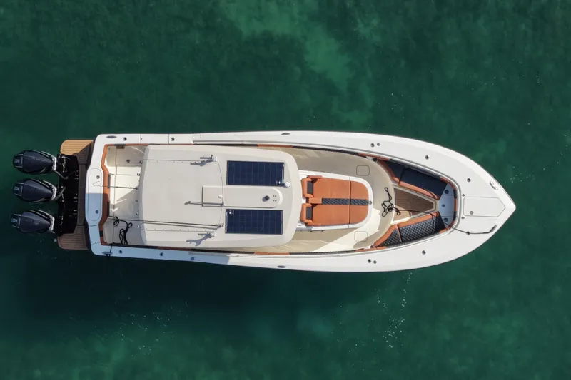  Yacht Photos Pics 2019 Scout 355 LXF boat, aerial view, on clear turquoise water.