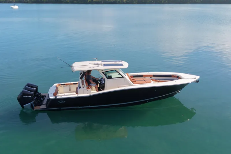  Yacht Photos Pics 2019 Scout 355 LXF boat on calm water, side view.