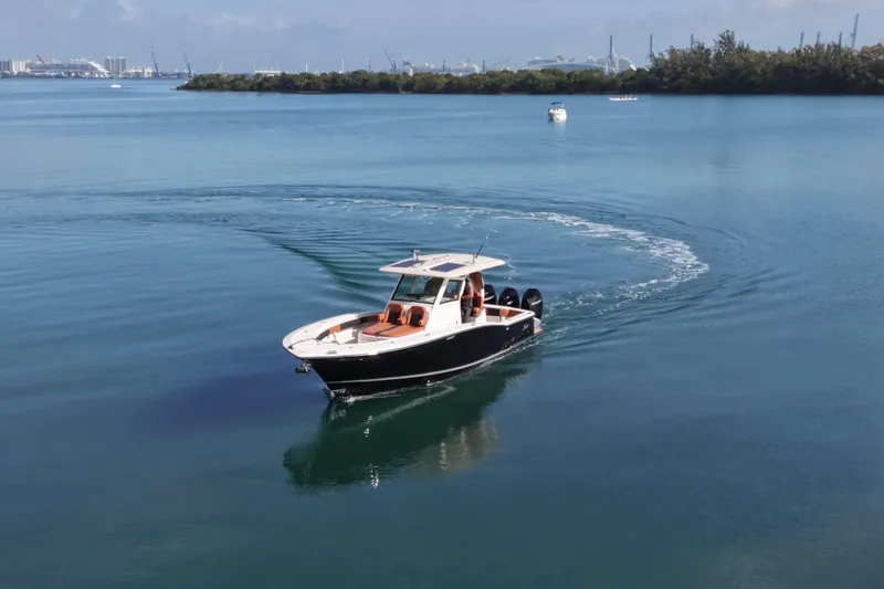  Yacht Photos Pics 2019 Scout 355 LXF boat cruising on calm blue water.