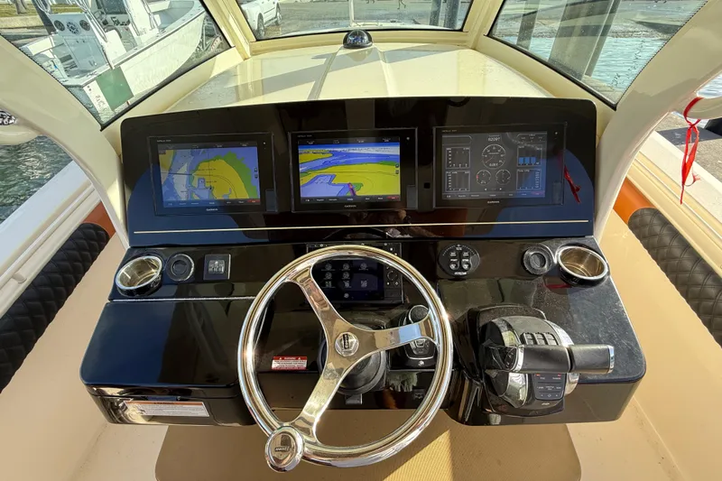  Yacht Photos Pics 2019 Scout 355 LXF boat dashboard with navigation screens and steering wheel.