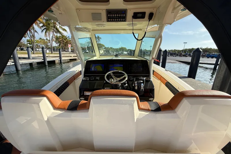  Yacht Photos Pics 2019 Scout 355 LXF boat cockpit with modern controls and waterfront view.