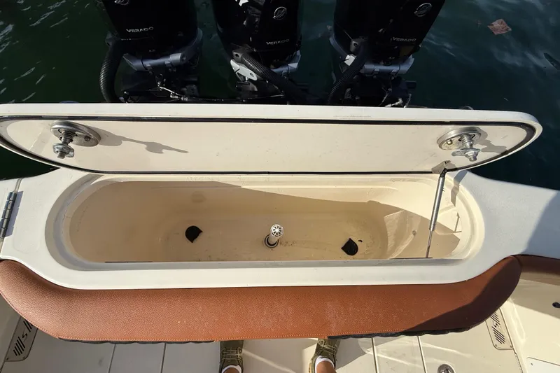  Yacht Photos Pics Open storage compartment on a 2019 Scout 355 LXF boat, with visible engines.