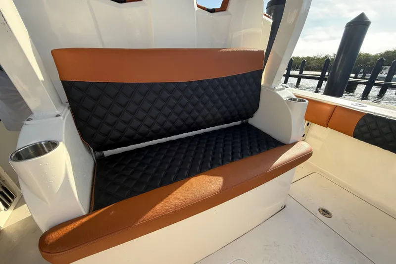  Yacht Photos Pics Luxurious seating on 2019 Scout 355 LXF boat with quilted upholstery and cup holders.
