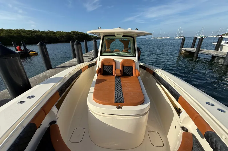  Yacht Photos Pics 2019 Scout 355 LXF boat docked, featuring luxurious seating and sleek design.
