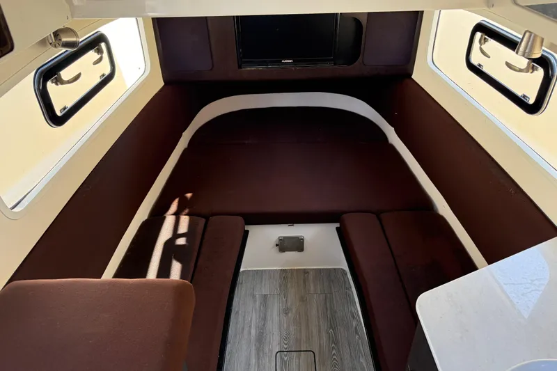  Yacht Photos Pics 2019 Scout 355 LXF cabin interior with brown seating and windows.