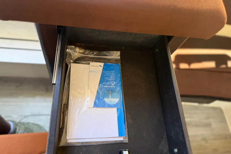  Yacht Photos Pics Open storage compartment in 2019 Scout 355 LXF boat with documents inside.