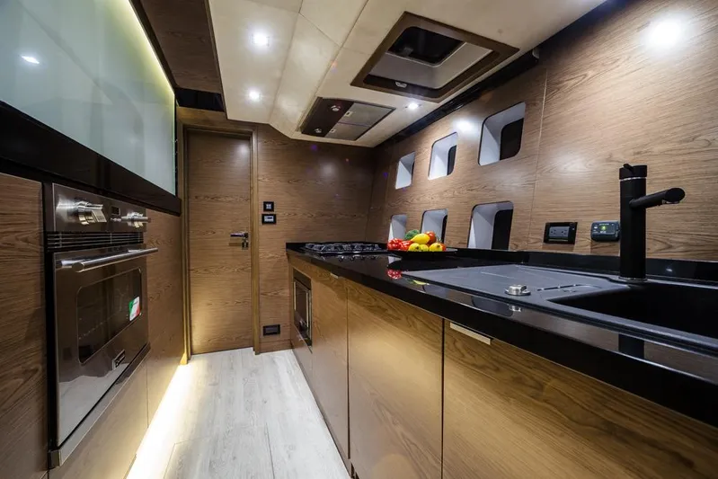 Darlin ( Ex Fine Line) Yacht Photos Pics Luxurious kitchen interior of 2015 Sunreef 60 LOFT yacht with modern wood finish.