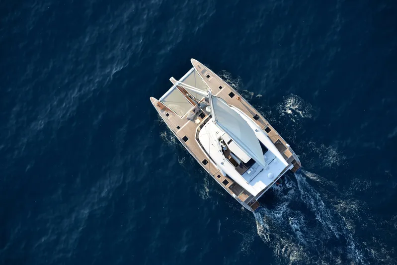 Darlin ( Ex Fine Line) Yacht Photos Pics Aerial view of 2015 Sunreef 60 LOFT catamaran sailing on deep blue ocean.