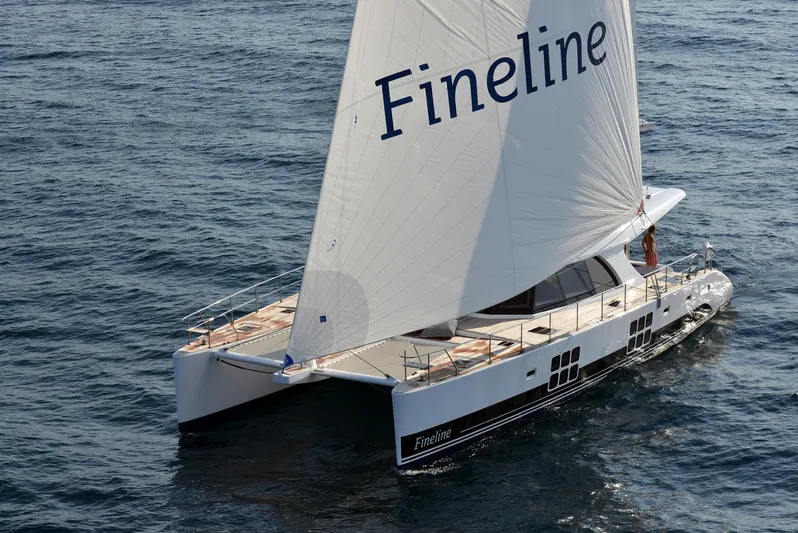 Darlin ( Ex Fine Line) Yacht Photos Pics Sunreef 60 LOFT 2015 catamaran sailing on open water with "Fineline" on sail.
