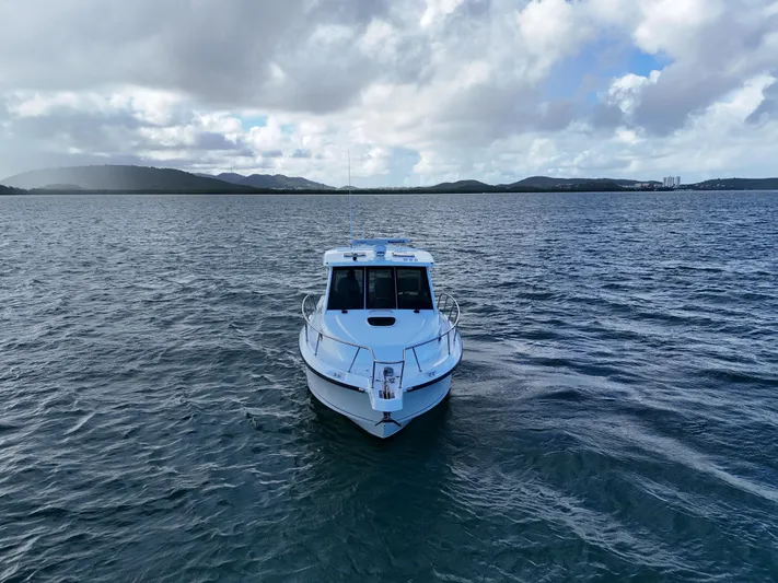 Del Mar Yacht Photos Pics 2015 Boston Whaler 345 Conquest on open water under cloudy sky.
