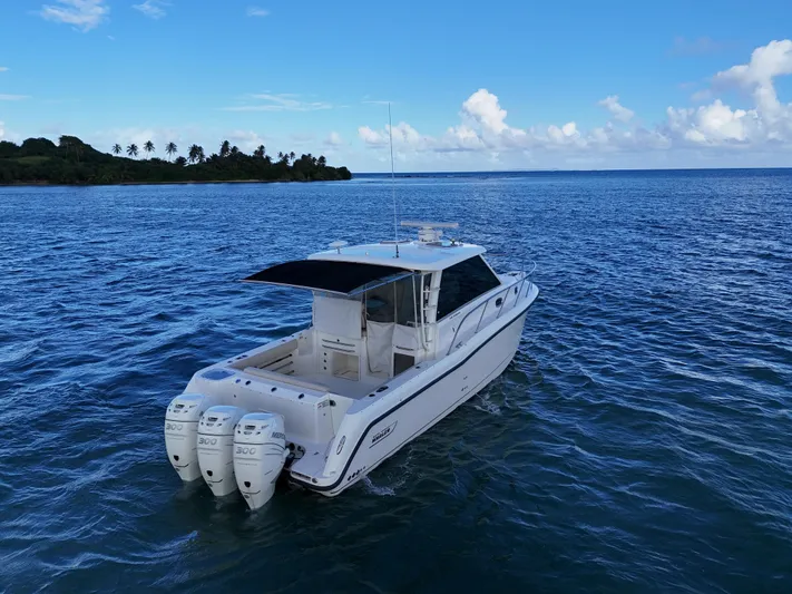 Del Mar Yacht Photos Pics 2015 Boston Whaler 345 Conquest boat on open water, clear sky, distant shoreline.