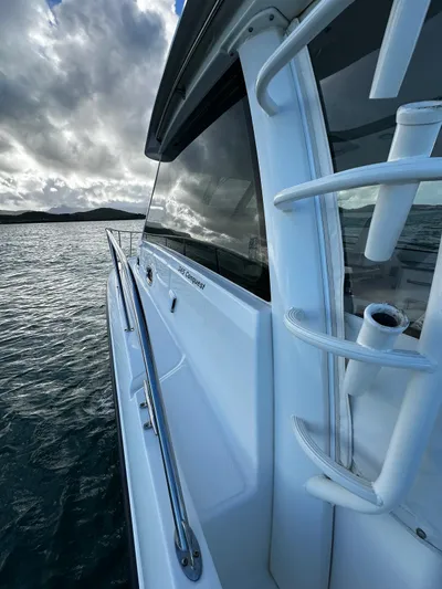 Del Mar Yacht Photos Pics 2015 Boston Whaler 345 Conquest on water, showcasing sleek design and sturdy railing.