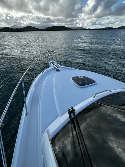 Del Mar Yacht Photos Pics Boston Whaler 345 Conquest 2015 cruising on serene waters under a cloudy sky.