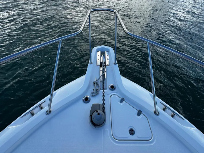 Del Mar Yacht Photos Pics Bow of 2015 Boston Whaler 345 Conquest on water, featuring anchor and railings.