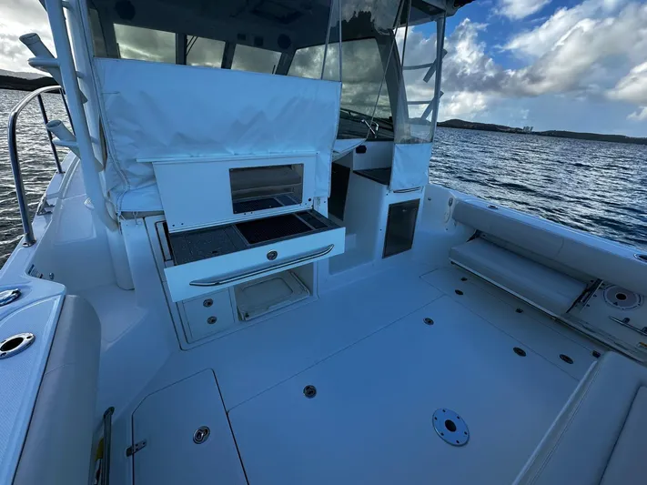Del Mar Yacht Photos Pics 2015 Boston Whaler 345 Conquest boat interior with seating and storage, on calm water.