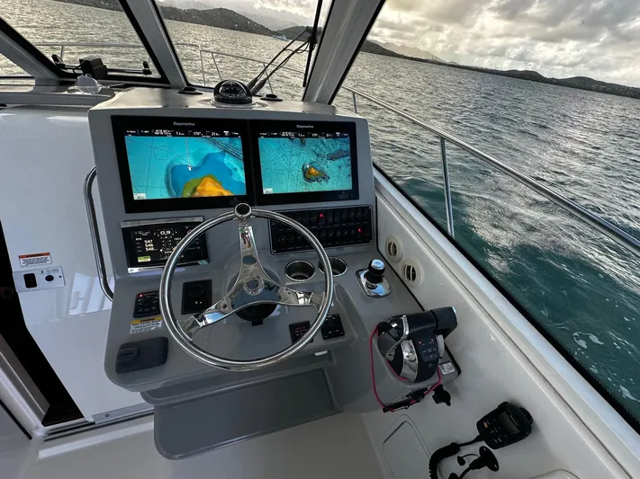 Del Mar Yacht Photos Pics Boston Whaler 345 Conquest 2015 helm with dual navigation screens on open water.