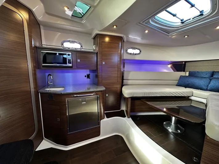 Del Mar Yacht Photos Pics Luxurious interior of 2015 Boston Whaler 345 Conquest with modern kitchen and seating area.