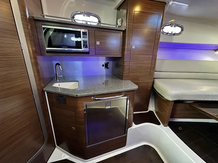 Del Mar Yacht Photos Pics Luxurious 2015 Boston Whaler 345 Conquest cabin with modern kitchenette and seating area.