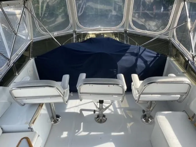 The Jolly Rogers Yacht Photos Pics 1987 Hi-Star Sportfish boat interior with white seating and covered console.
