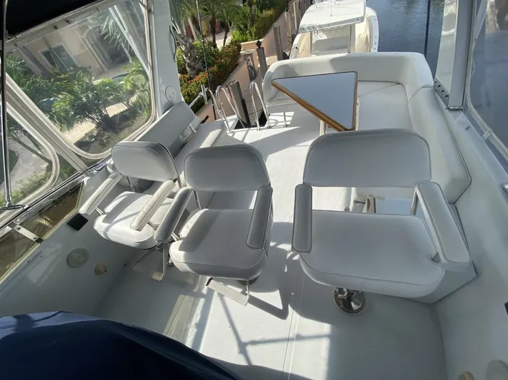 The Jolly Rogers Yacht Photos Pics 1987 Hi-Star Sportfish boat interior with white seating and table.