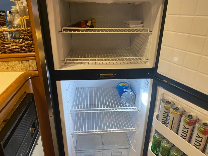 The Jolly Rogers Yacht Photos Pics Refrigerator inside a 1987 Hi-Star Sportfish boat with minimal contents.