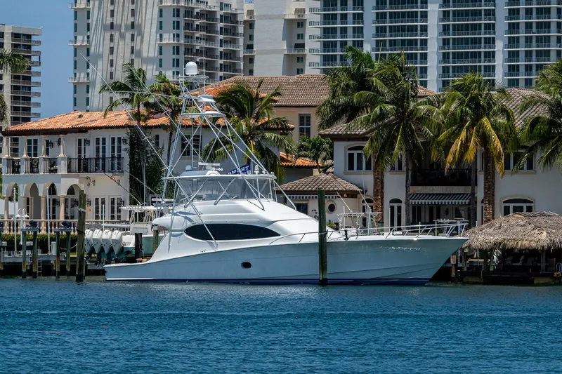 New Paint- 100hrs Yacht Photos Pics 2006 Hatteras 68 Convertible yacht docked near luxury waterfront homes.